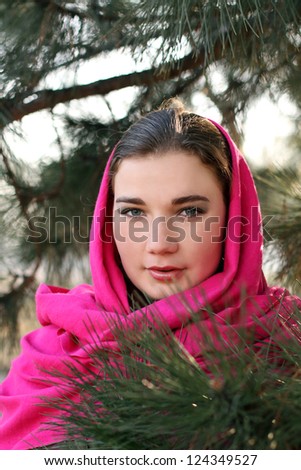 Outdoors portrait of lovely woman wearing scarf