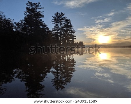 Similar – Image, Stock Photo The sun rises over the rural country highway with a farm silhouetted on the horizon. Fields and trees follow the sides of the road.