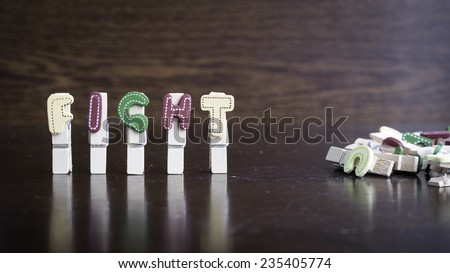 Common business terms - Slightly defocused and close-up of FIGHT word on clothes peg stick with lots of clothes peg at background