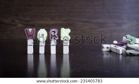 Common business terms - Slightly defocused and close-up of WORK word on clothes peg stick with lots of clothes peg at background