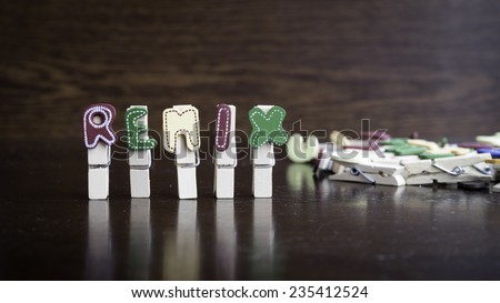 Common business terms - Slightly defocused and close-up of REMIX word on clothes peg stick with lots of clothes peg at background