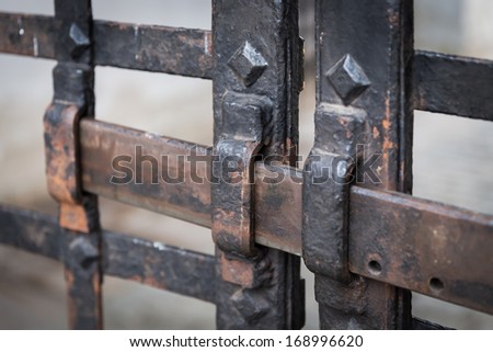 an old rusty metal bars with lock