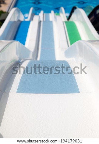 Colorful water park tubes and a swimming pool. Outdoor shot