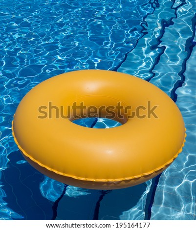 Inflatable Yellow Inner Tube Floating In Clear Blue Waters Stock Photo ...