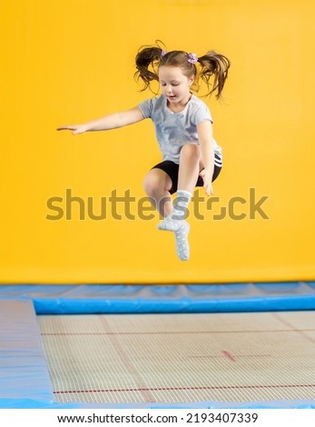 Similar – Image, Stock Photo Playful little girl jumping over sea waves on a sand beach at sunset