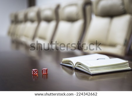 Closeup of dices on table in empty corporate conference room before business meeting in office