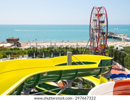 ANTALYA, TURKEY - MAY 11, 2014:  Colorful water park tubes and Ferris wheel in Delphin Imperial hotel on MAY 11, 2014 in Antalya.