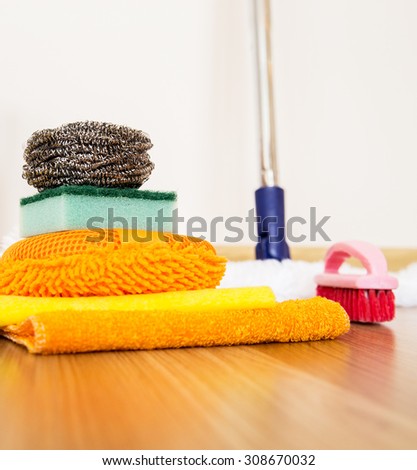 House cleaning supplies on a wooden floor for housekeeping service