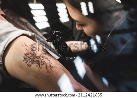 Similar – Image, Stock Photo Master doing tattoo on forearm of male customer