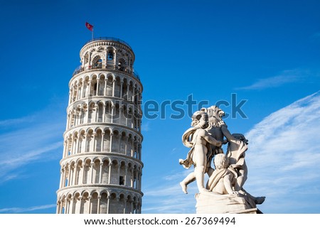 The statue of angels and the leaning tower. Square of Miracles in Pisa, Italy, Europe