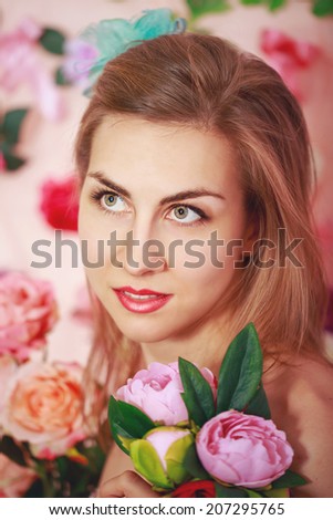 Young attractive girl with a bouquet of flowers portrait