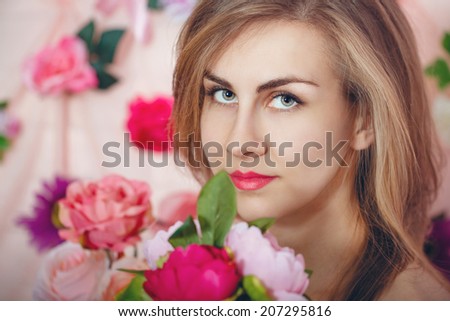 Young attractive girl with a bouquet of flowers portrait