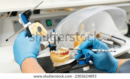 Image, Stock Photo Dentist working with denture in laboratory