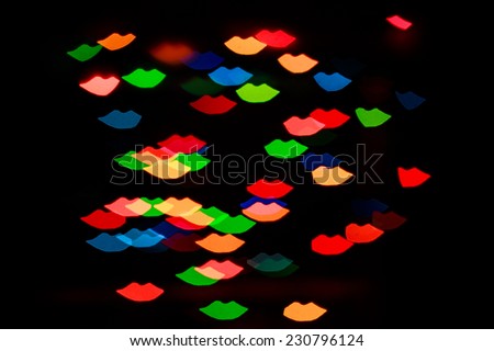 Multicolored abstract background of lights in the form of the lips is not in focus
