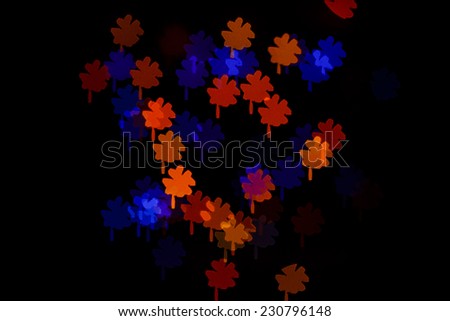 Multicolored abstract background of lights in the form of a clover is not in focus