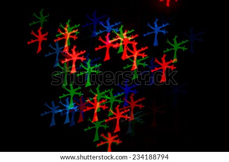 Multicolored abstract background of lights in a tree not in focus