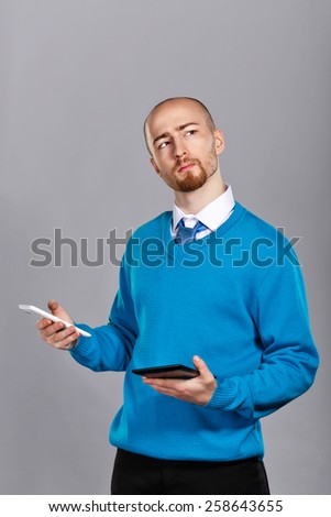 Businessman in shirt and tie talking on cell phone and holding a tablet PC. Business people. Concept of success.
