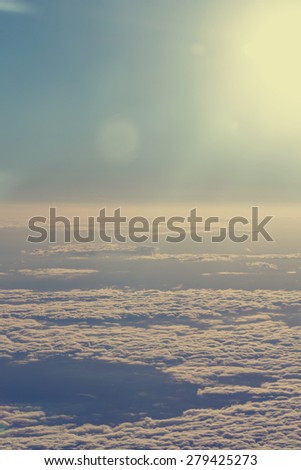 View of clouds from the window of a jet aircraft. Flying above the clouds. Clouds at dawn. Concept travel.