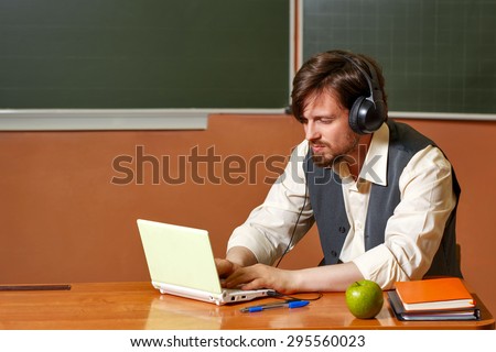 The teacher listens to music in between classes. Back to school.