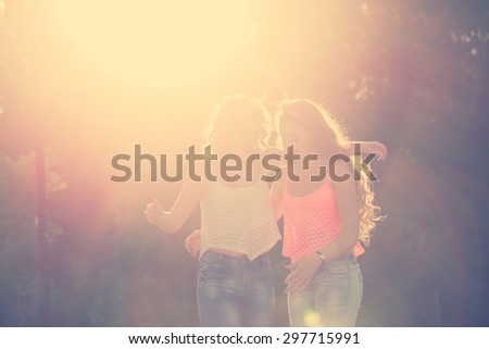 Best girlfriends hug. Girls dressed in the style of Pin-up girl. Hipster. Warm toning. Sunset. The concept of true friendship.