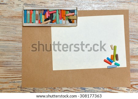 Set pastel pencils in the box. Artistic set. A blank sheet of paper. Space for text. Development of creative thought.