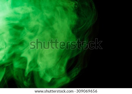 Abstract green hookah smoke on a black background. Photographed using a gel filter. The concept of of unhealthy.