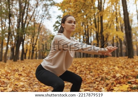 Similar – Image, Stock Photo Focused sportswoman doing squats with elastic band in apartment