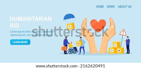 Humanitarian aid. Social worker distributing food, medical supplies to needy people. Volunteering, donation, humanitarian relief. Volunteers giving help boxes to refugees Government assistance to poor