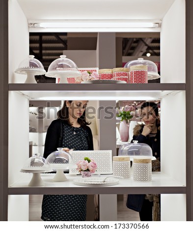 MILAN, ITALY - JANUARY 20, 2014: a couple of women\'s looks household items at HOMI,the new big MACEF, home international show in the sector of interior design on JANUARY 20, 2014 in Milan.