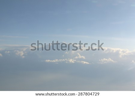 Skyscape - sky landscape with blue sky and soft white fluffy clouds seen from an airplane. Clouds texture; cloudscape.