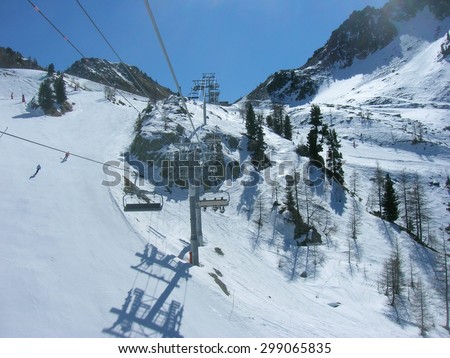 ISOLA, FRANCE - MARCH 26, 2012: Ski runs and a chair lift in ISOLA 2000, a French ski resort in the southern French Alps, located about 90 km from Nice, on a sunny day.