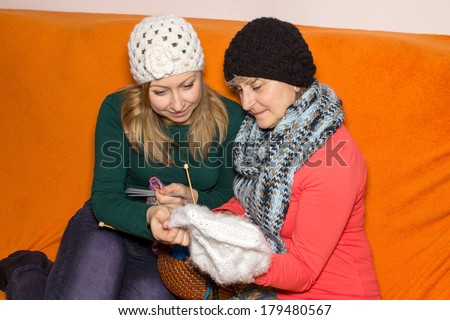 Woman learns to knit from a pensioner
