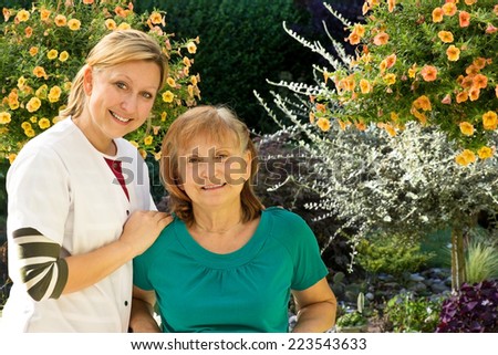 One Senior is being supervised by a nurse in a garden