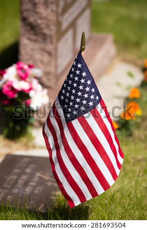 USA flag placed by Veteran\'s tombstone.