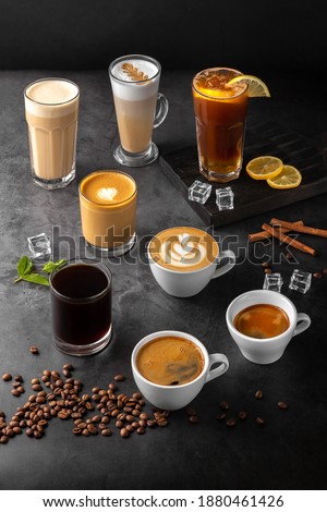 still life composition with glasses and cups of espresso, latte americano, brewed, raf coffee, cappuccino with rosetta latte and green matcha art and roasted coffee beans on a black marble background Zdjęcia stock © 