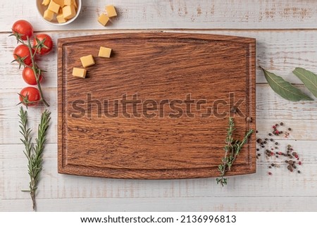 Similar – Image, Stock Photo Food background with cutting board and various healthy flavor seasoning ingredients: herbs, garlic, olive oil, chili powder and pepper. Cooking at home with flavorful spice. Top view. Border