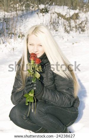 pretty woman with red roses on winter background