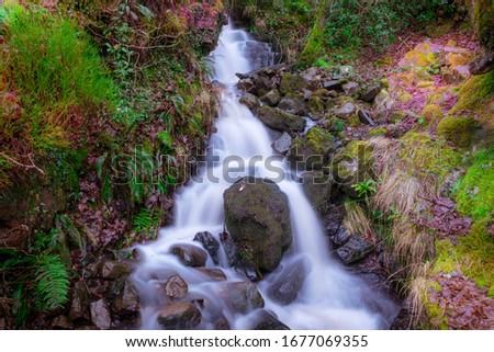 A mini waterfall on the Elidir Trail; entrance to the fairy kingdom on the banks of the Nedd. Long exposure Stok fotoğraf © 