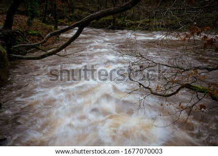 Fast flowing water at the confluence of two rivers, the Afon Pyrddin meeting the Afon Neath or Nedd. Long-exposure Stok fotoğraf © 