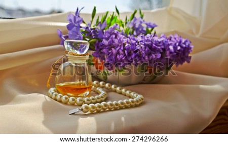 beautiful Viola flowers with Vintage Perfume Bottle, pearls and lace