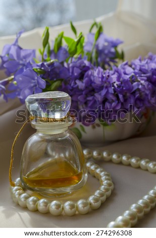 beautiful Viola flowers with Vintage Perfume Bottle, pearls and lace