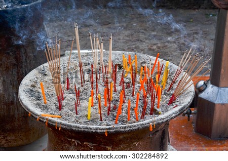 Red Incense sticks in ash, buddhist temple