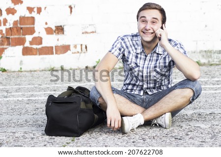 Smiling Guy on a cell phone outdoors