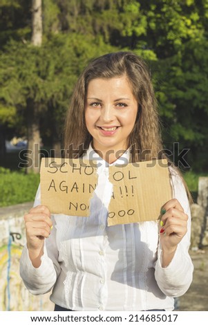 Girl pulls the hair and holding a paper with the inscription not in school