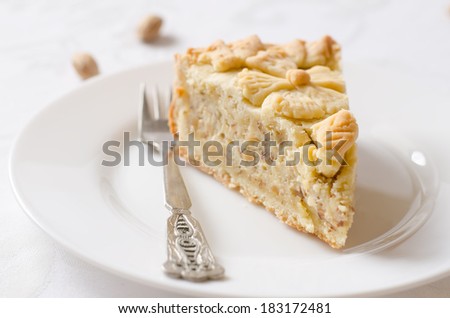 pie patterned in the form of flowers with custard on a white background (the Basque cake).