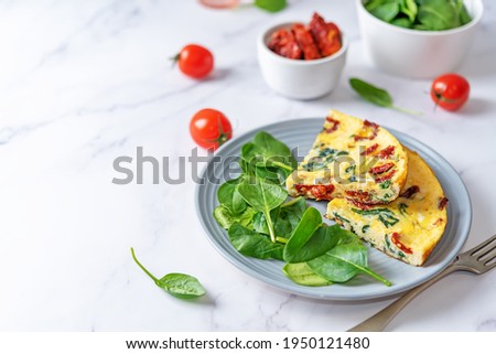 Spinach Dried tomatoes Frittata in a plate. toning. selective focus Foto d'archivio © 