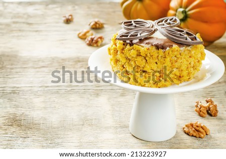 pumpkin cheesecake with chocolate and walnuts on a wood background. tinting. selective focus