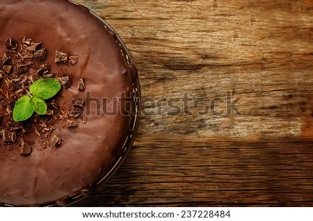 chocolate cheesecake with chocolate glaze on dark wood background. tinting. selective focus