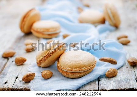 macaron with cream cheese on a white wood background. tinting. selective focus