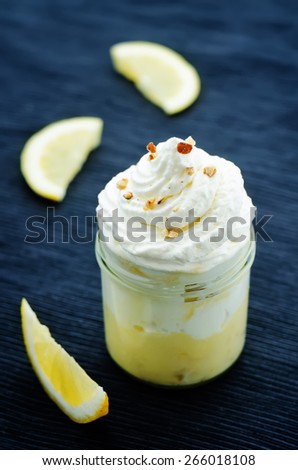 layered dessert with lemon cream, ice cream and whipped cream. tinting. selective focus